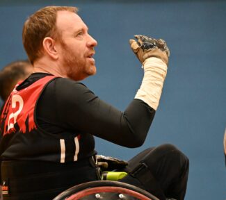 The London Crusaders player/coach talks to his players during a game