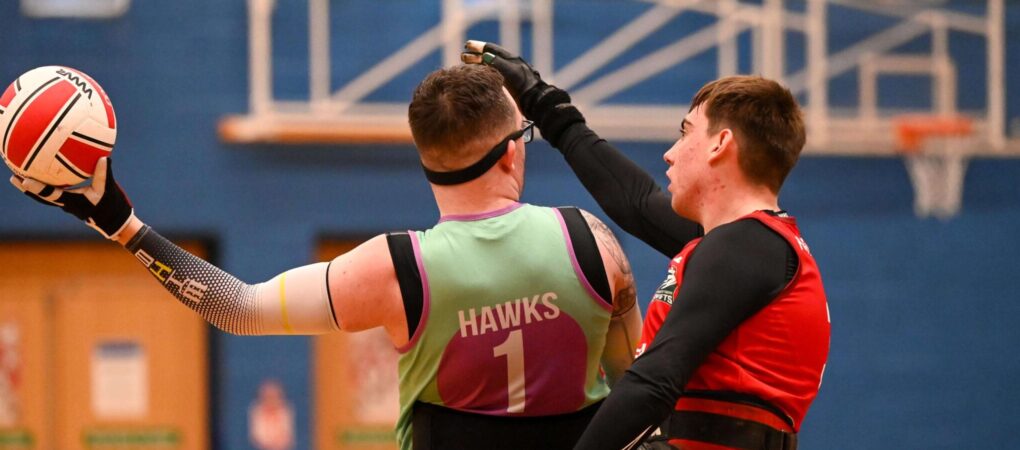 Luke Collier holding the ball in a wheelchair rugby game