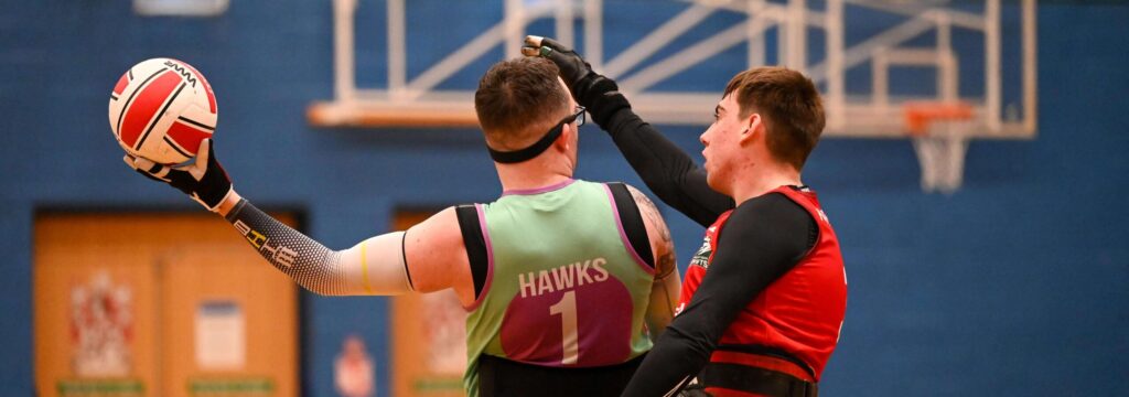 Luke Collier holding the ball in a wheelchair rugby game