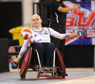Jack Smith Punting the ball in a wheelchair rugby match